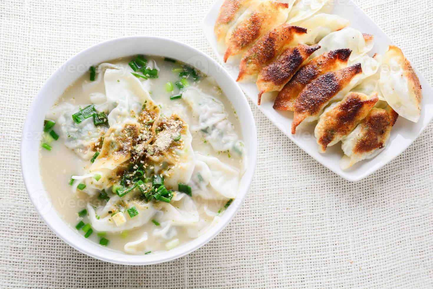 Wonton soup with spring onion served in a white bowl, selective focus photo