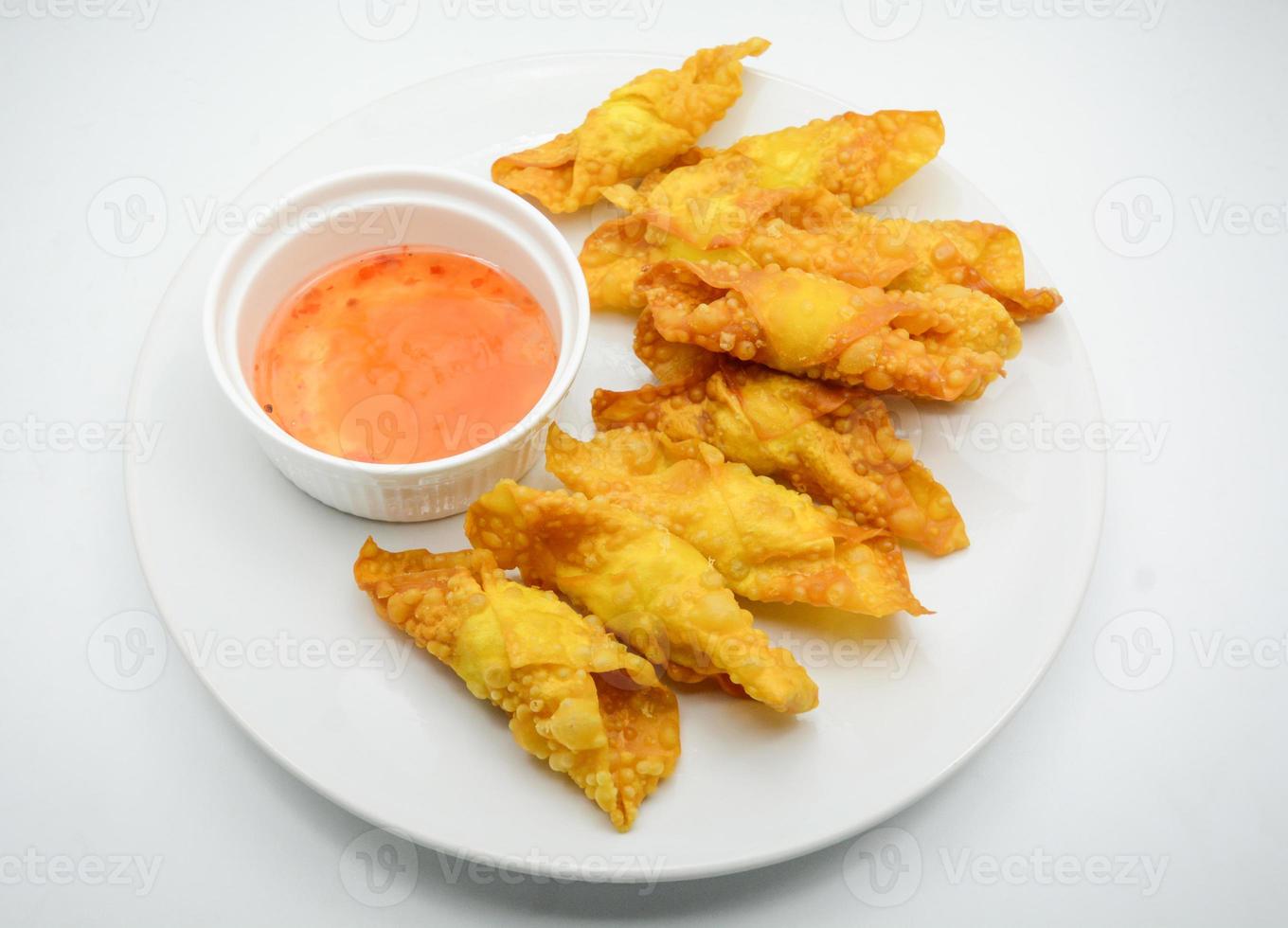 Deep Fried Won ton on white plate with dip source photo