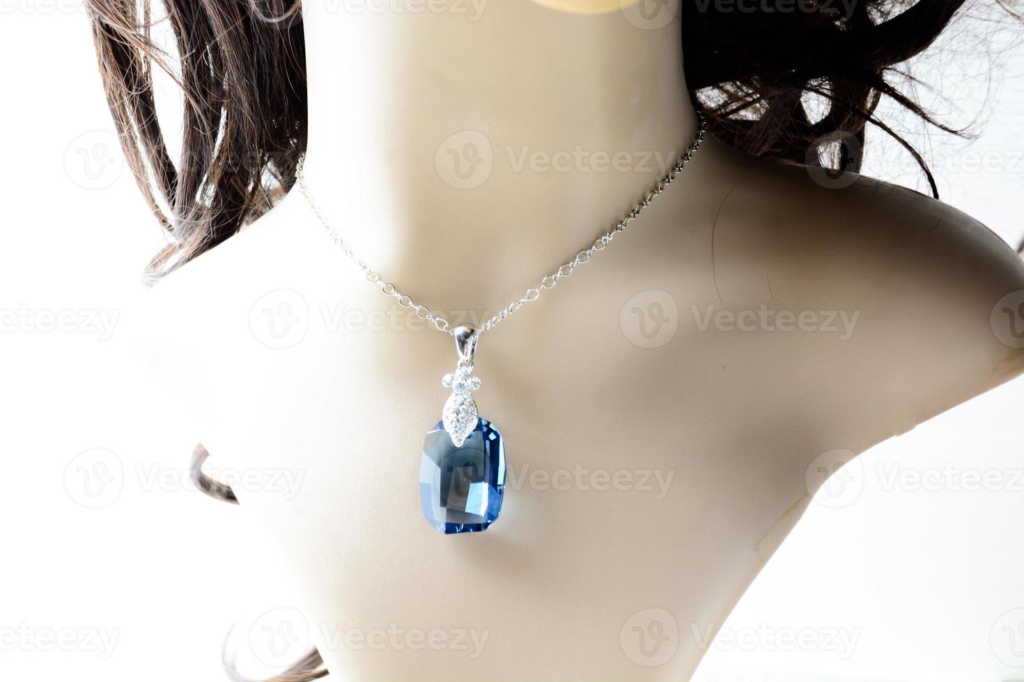 Crystal necklace on mannequin and on white background photo