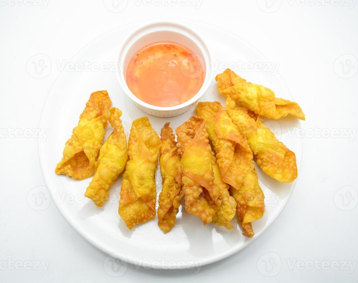 Deep Fried Won ton on white plate with dip source photo