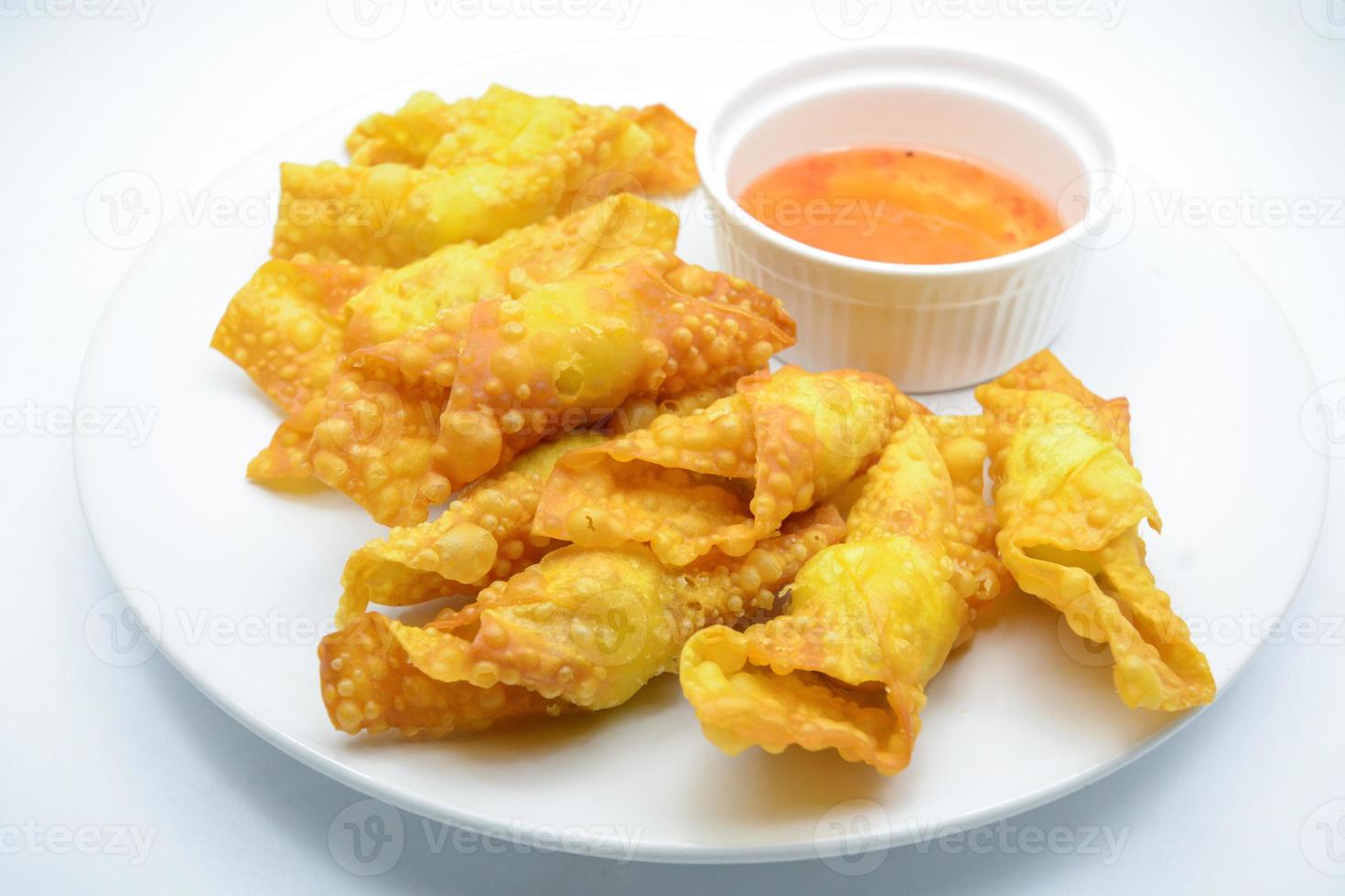 Deep Fried Won ton on white plate with dip source photo