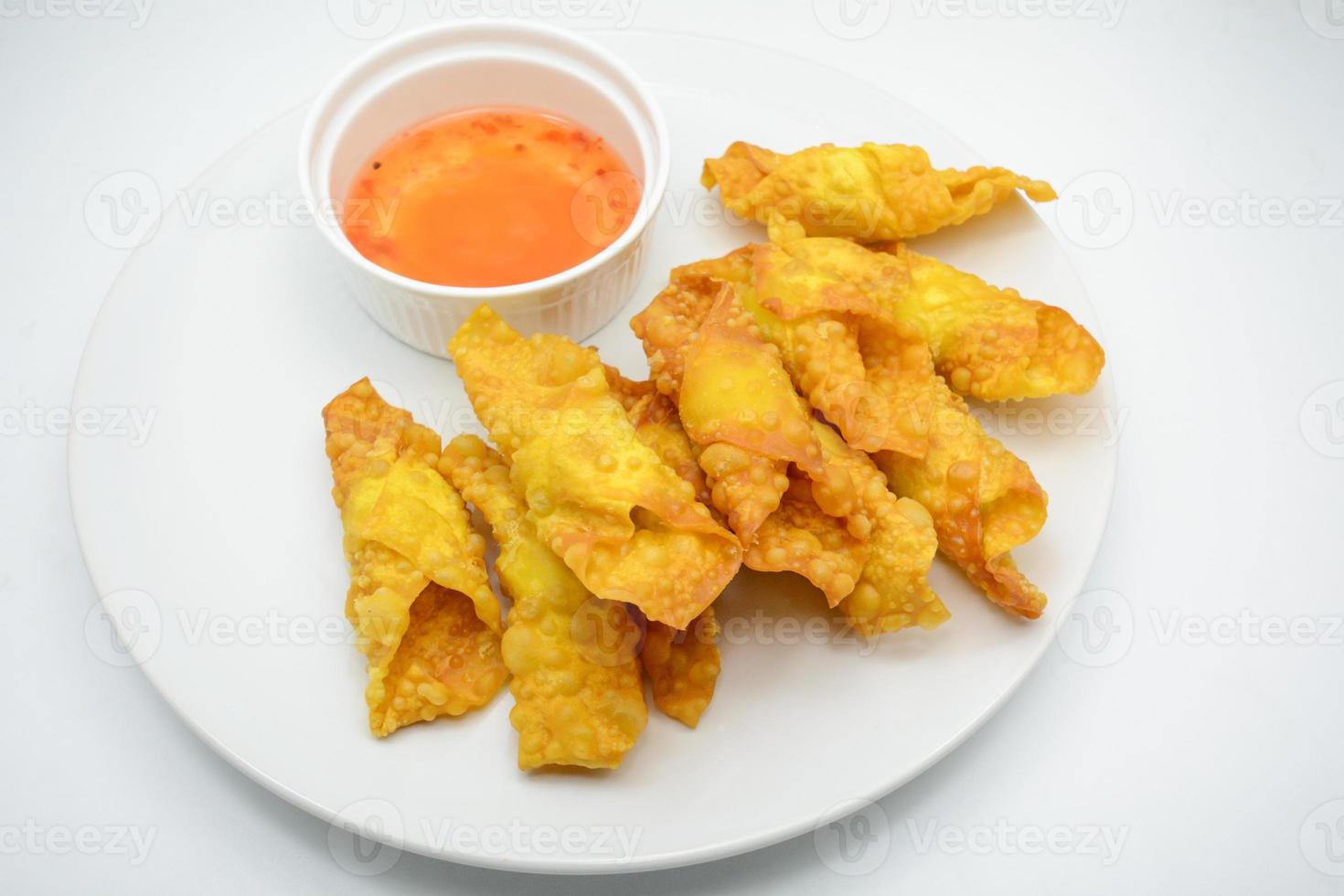 Deep Fried Won ton on white plate with dip source photo