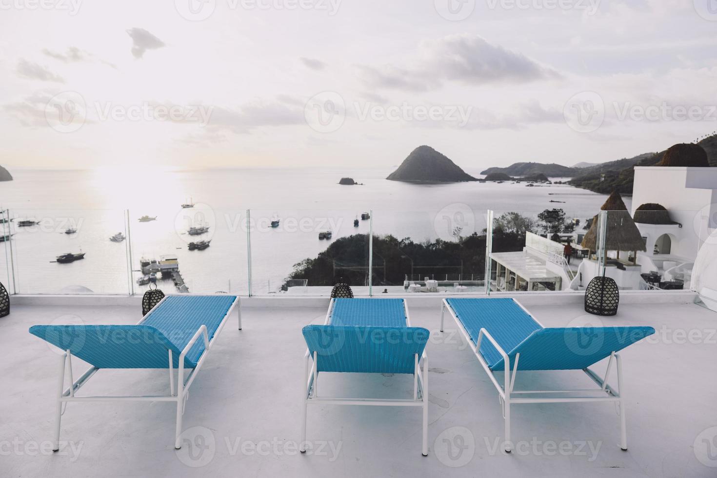 Row of relaxing chair on top with sea view photo