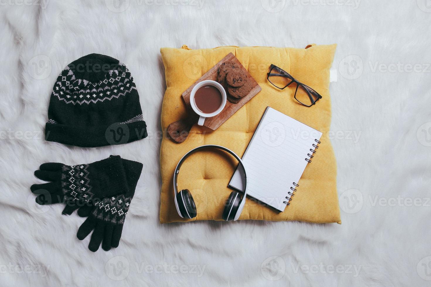 Creative flat lay composition of winter gloves, beanie and work accessories for winter background photo