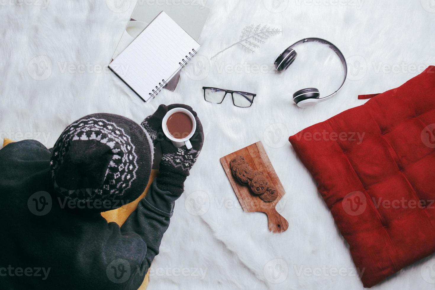 Man enjoying winter season with hot chocolate and cookies photo