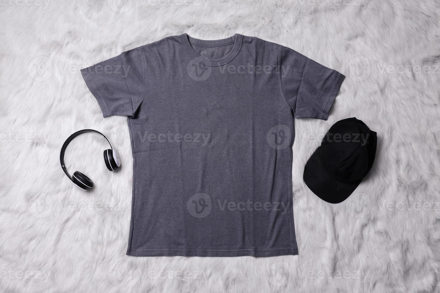 Grey t-shirt mockup with man accessories on grey background. Flat lay tee template photo