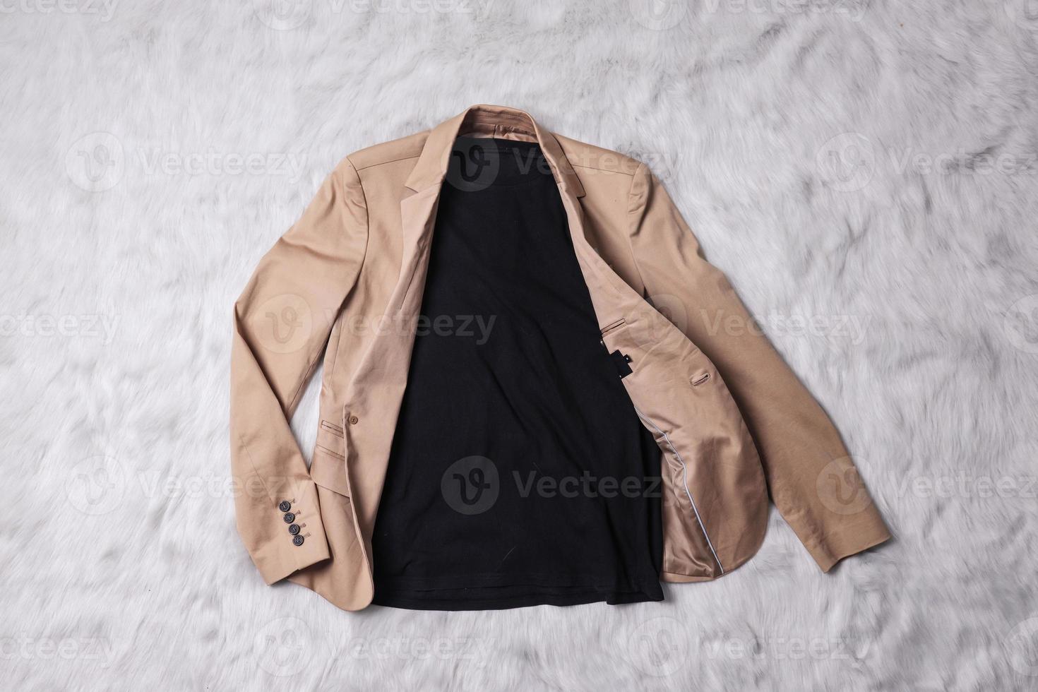 Black t-shirt mockup with men brown blazer as outer laying on grey background. Flat lay tee template photo