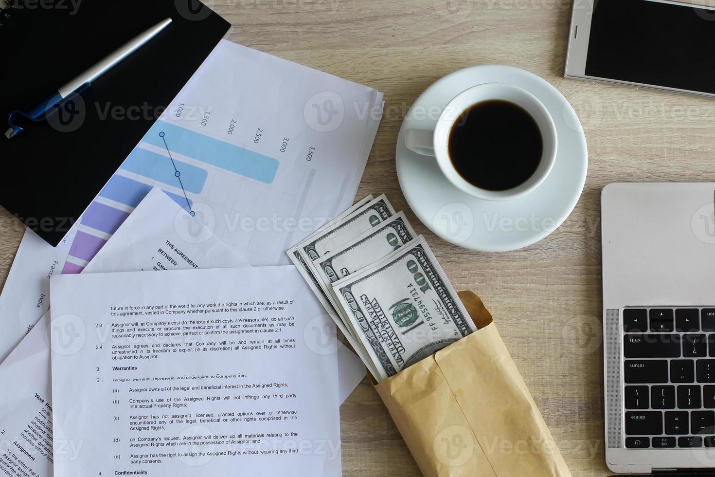 Top view Dollar bills in brown envelope on office desk. Bribery and corruption concept photo