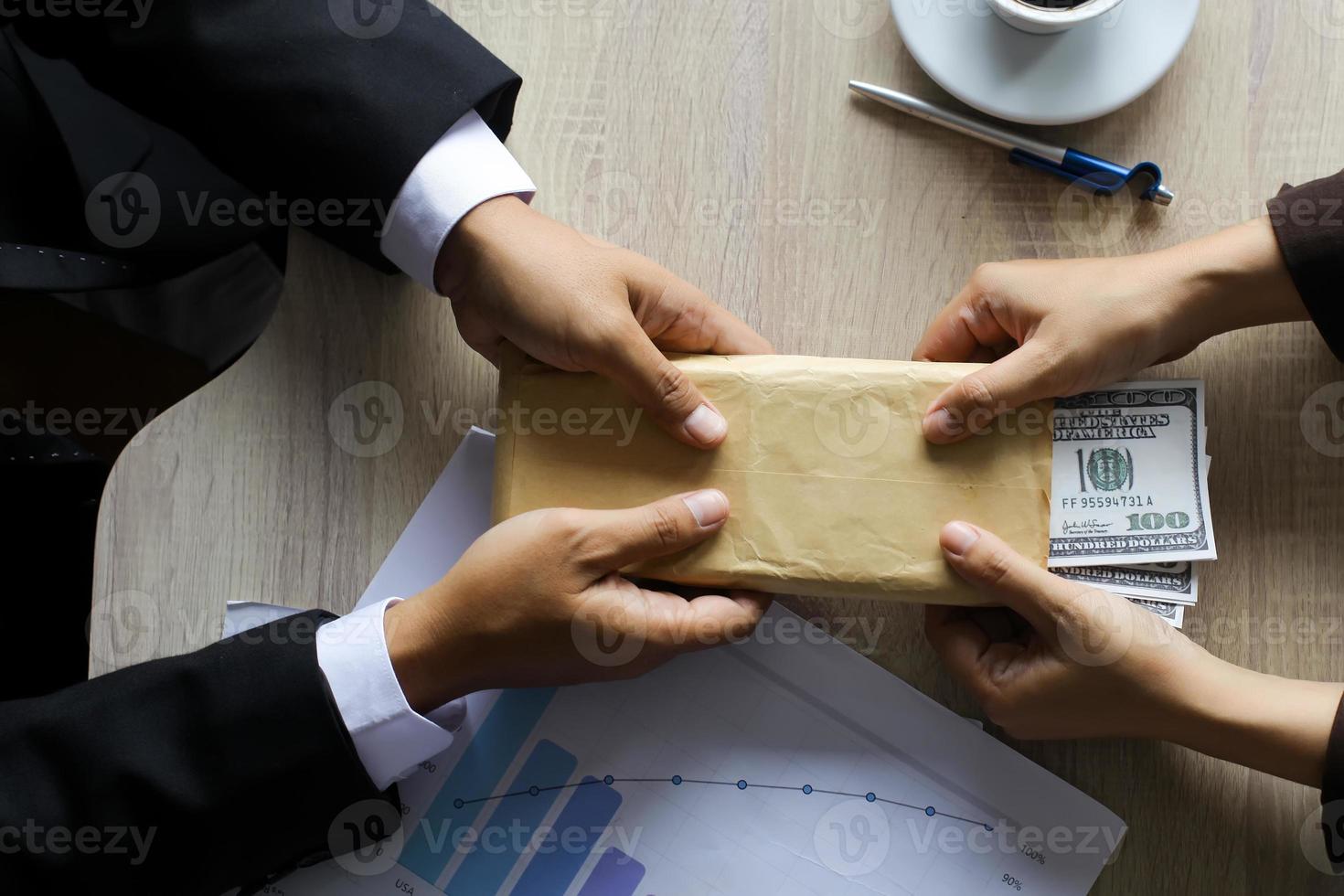 Business man receiving money to take the bribe, the concept of corruption and bribery photo