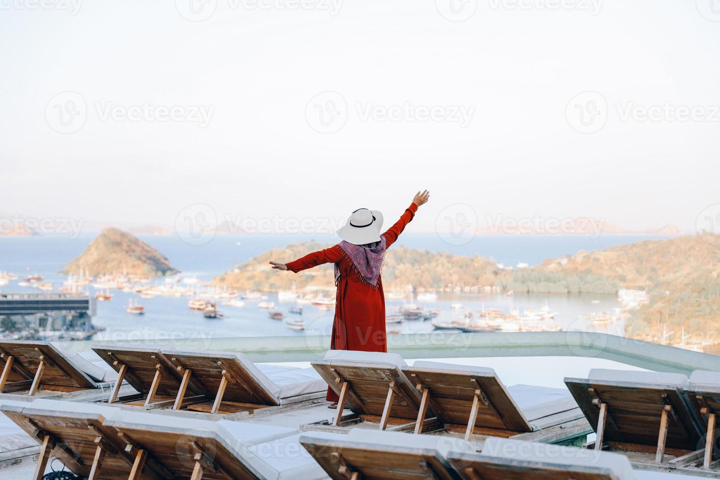 Freedom woman enjoying sea view from rooftop photo