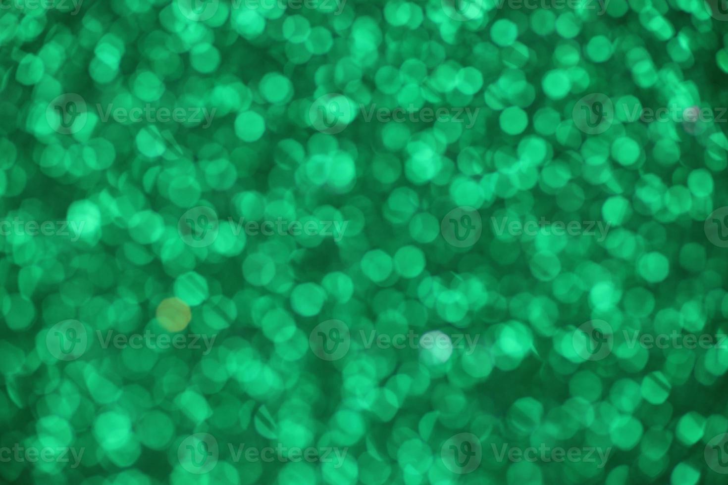 Green sparkle blurry background with fuzzy dots texture photo