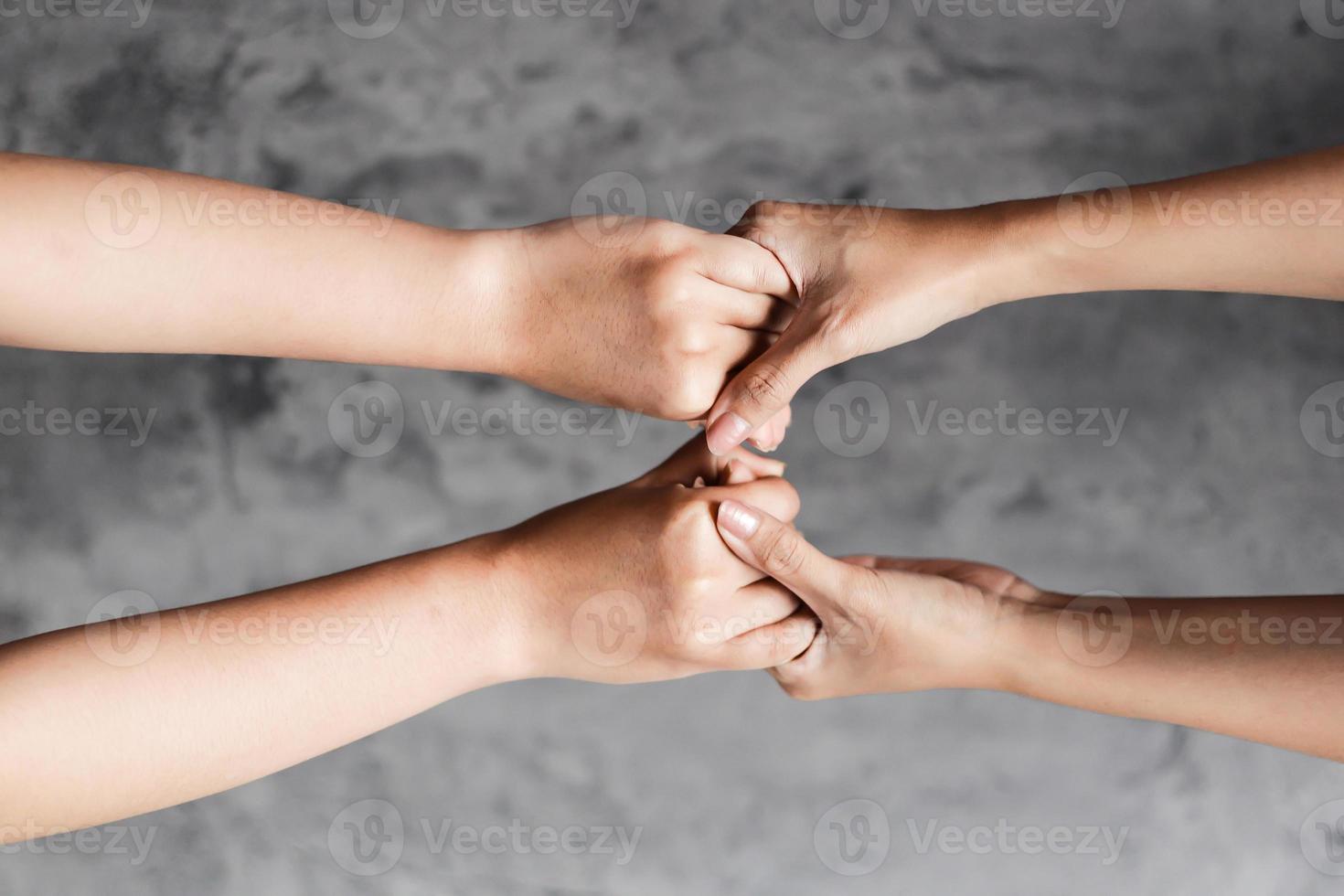 Close up of hands holding each other for togethersess concept photo