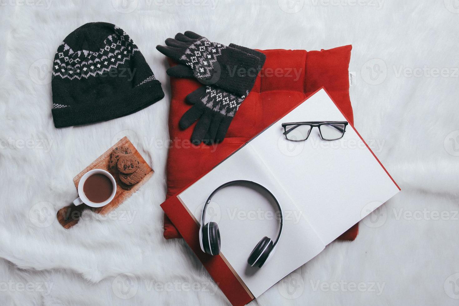 Creative flat lay composition of winter gloves, beanie and work accessories for winter background photo