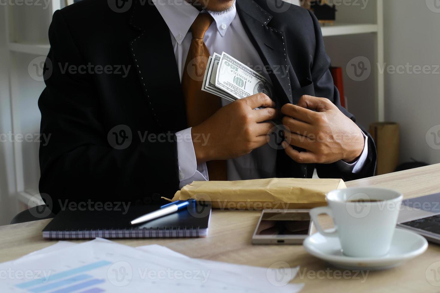 Corruption and bribery, Businessman receiving money on his office desk photo