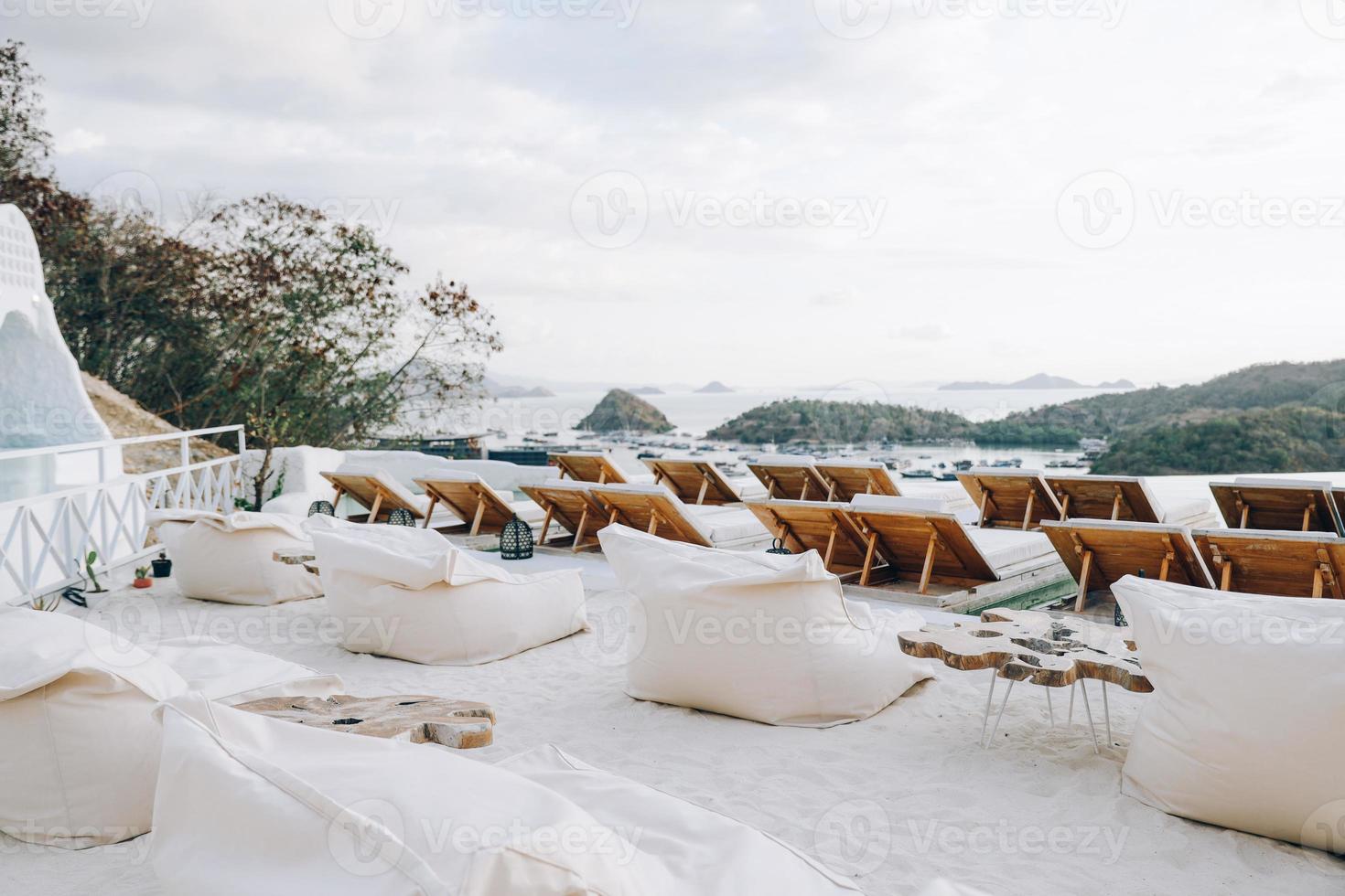 Row of relaxing chair on top with sea view photo
