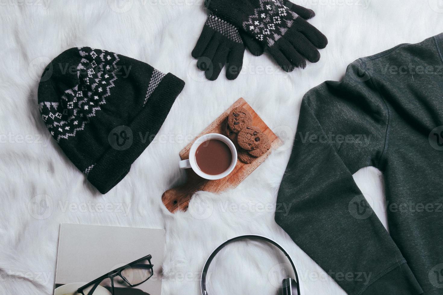 Creative flat lay of sweater, beanie, winter gloves for winter season background photo