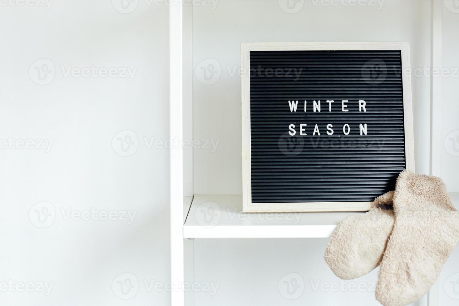 Winter background concept with winter season writing on blackboard photo