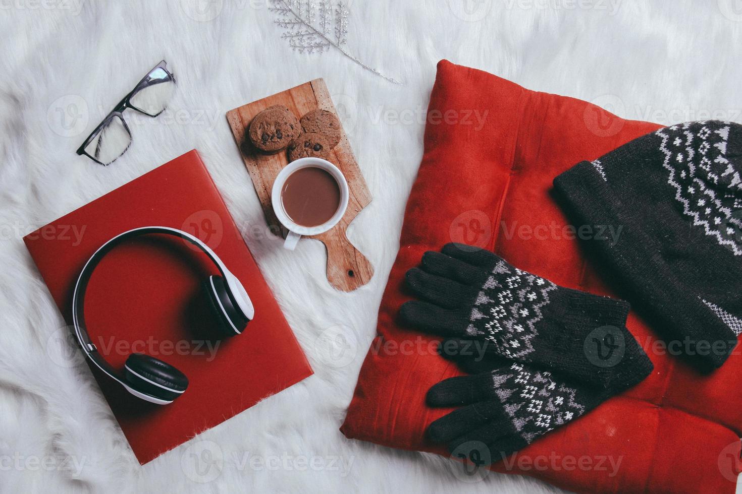 Creative flat lay composition of winter gloves, beanie and work accessories for winter background photo