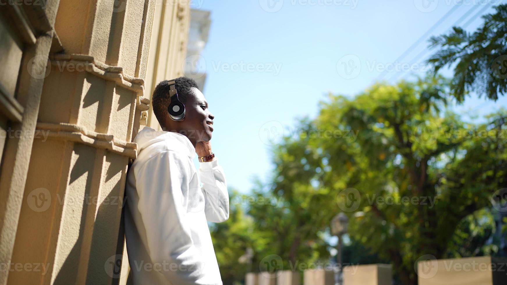 Afro American man having fun walking in city center - Happy young guy enjoying time a sunset outdoor - Millennial generation lifestyle and positive people attitude concept photo