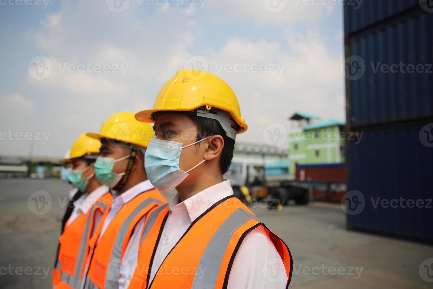 Group of industry workers control loading containers in the container terminal, during covid-19 check. photo