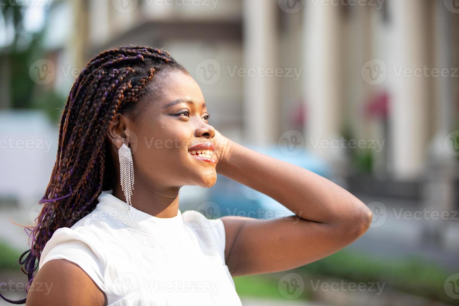 Young Black skin African American woman wearing casual clothes, standing on city background on positive, smiling confident. Self-love and self-care photo