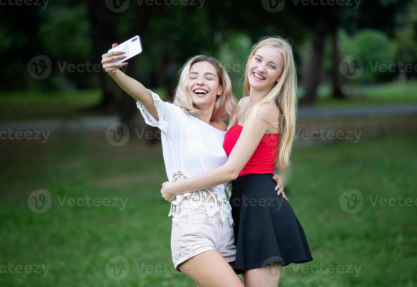 Portrait of two young friends outdoors. photo