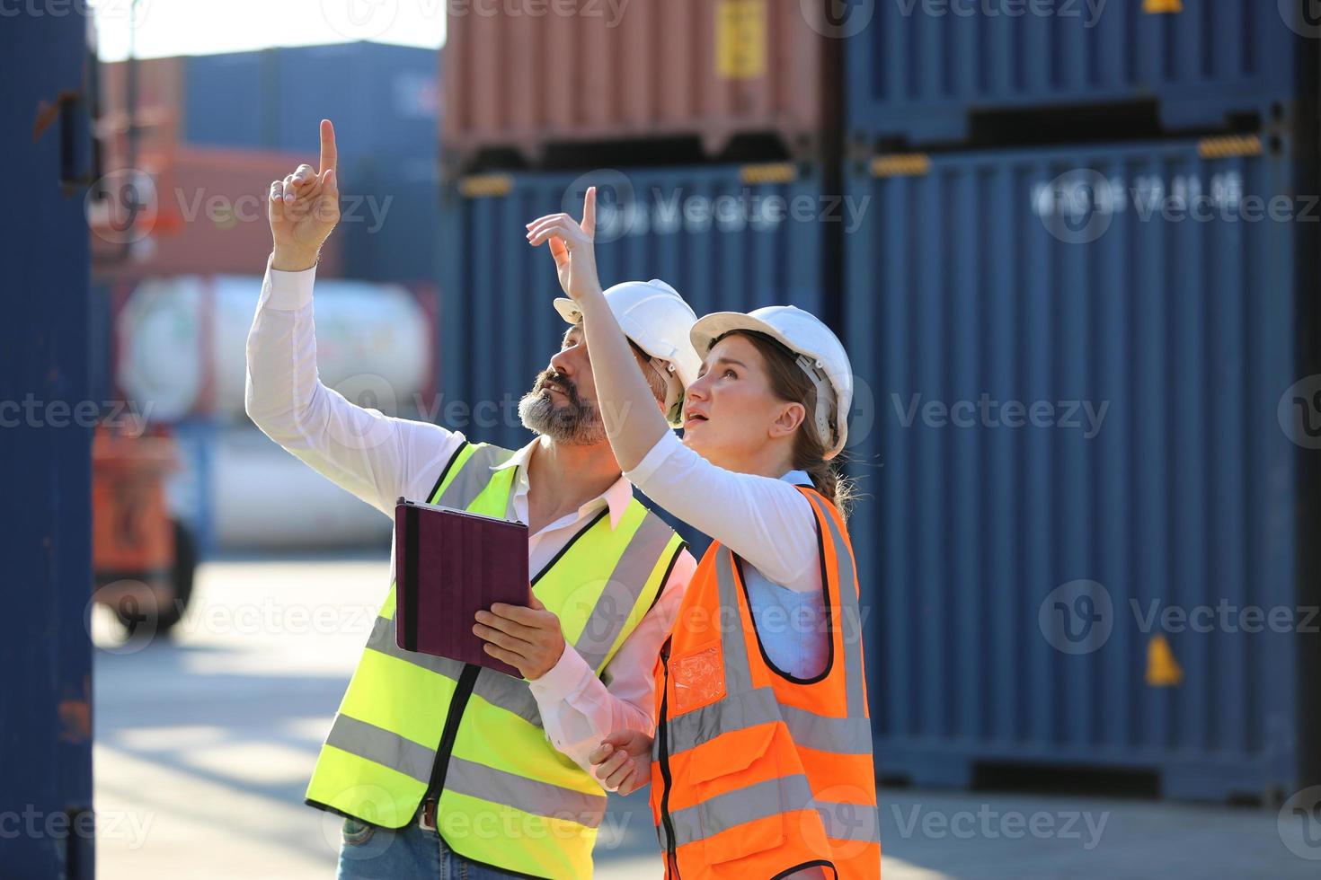 Foreman checking containers in the terminal, at import and export business logistic company. photo