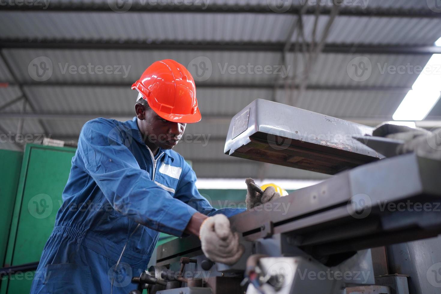 Maintenance Engineers is working in front of the automated CNC machinery repair on a maintenance checklist at the production line. photo