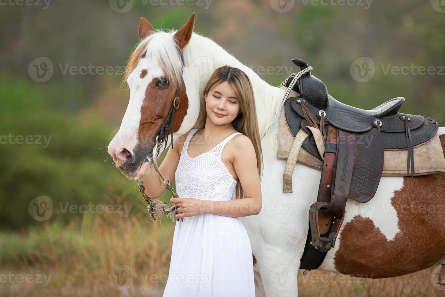 Young woman with her horse in evening sunset light. Outdoor photography with fashion model girl. Lifestyle mood photo