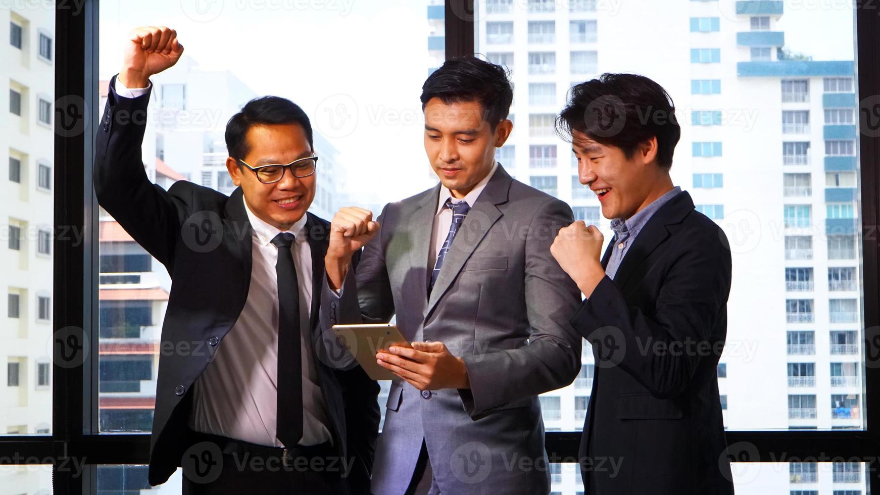 Successful business people standing together widen out showing strong relationship of worker community. A team of businessman and businesswoman expressing a strong group teamwork at the modern office. photo