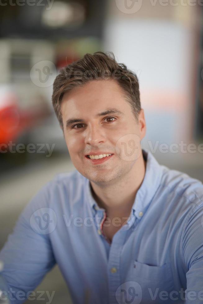 Portrait of handsome man on blue shirt standing at outdoor. photo