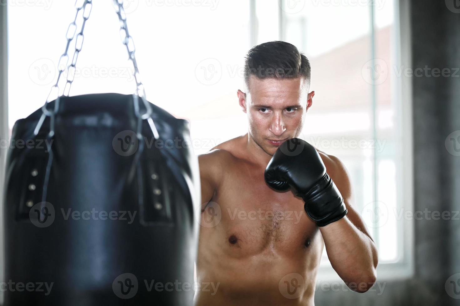 young man training boxing at fitness gym. photo