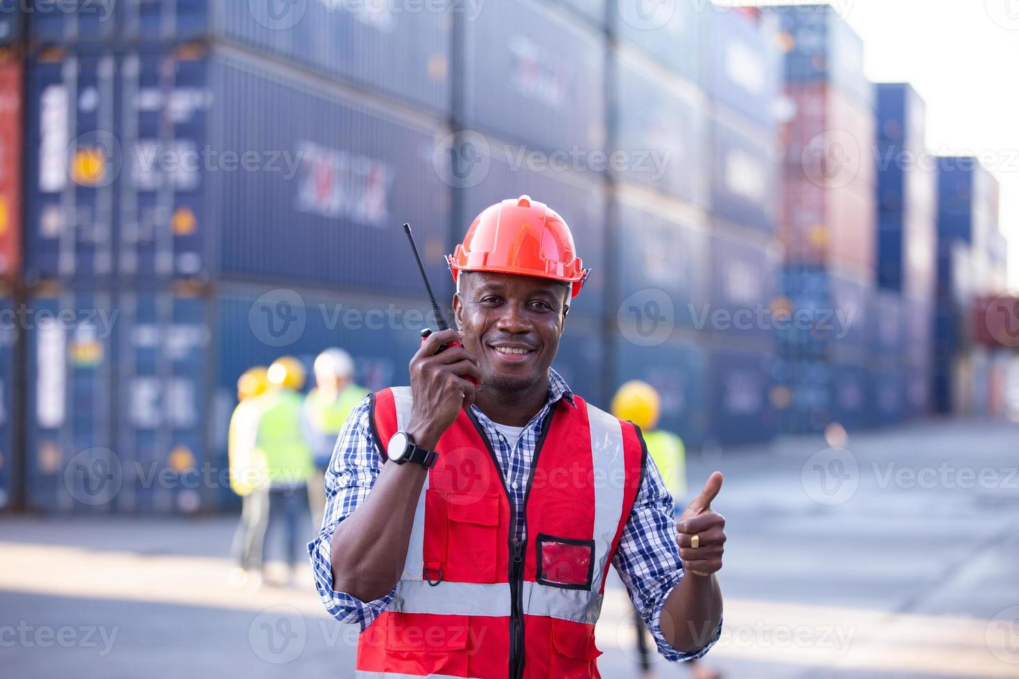 Engineer or supervisor checking and control loading Containers box from Cargo at harbor. Foreman control Industrial Container Cargo freight ship at industry. Transportation and logistic concept. photo