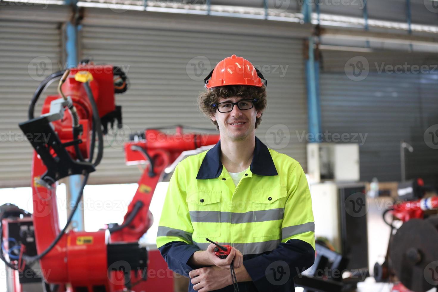 engineer checking control panel and teaching new Automatics robot arm and operating control machine in factory. photo