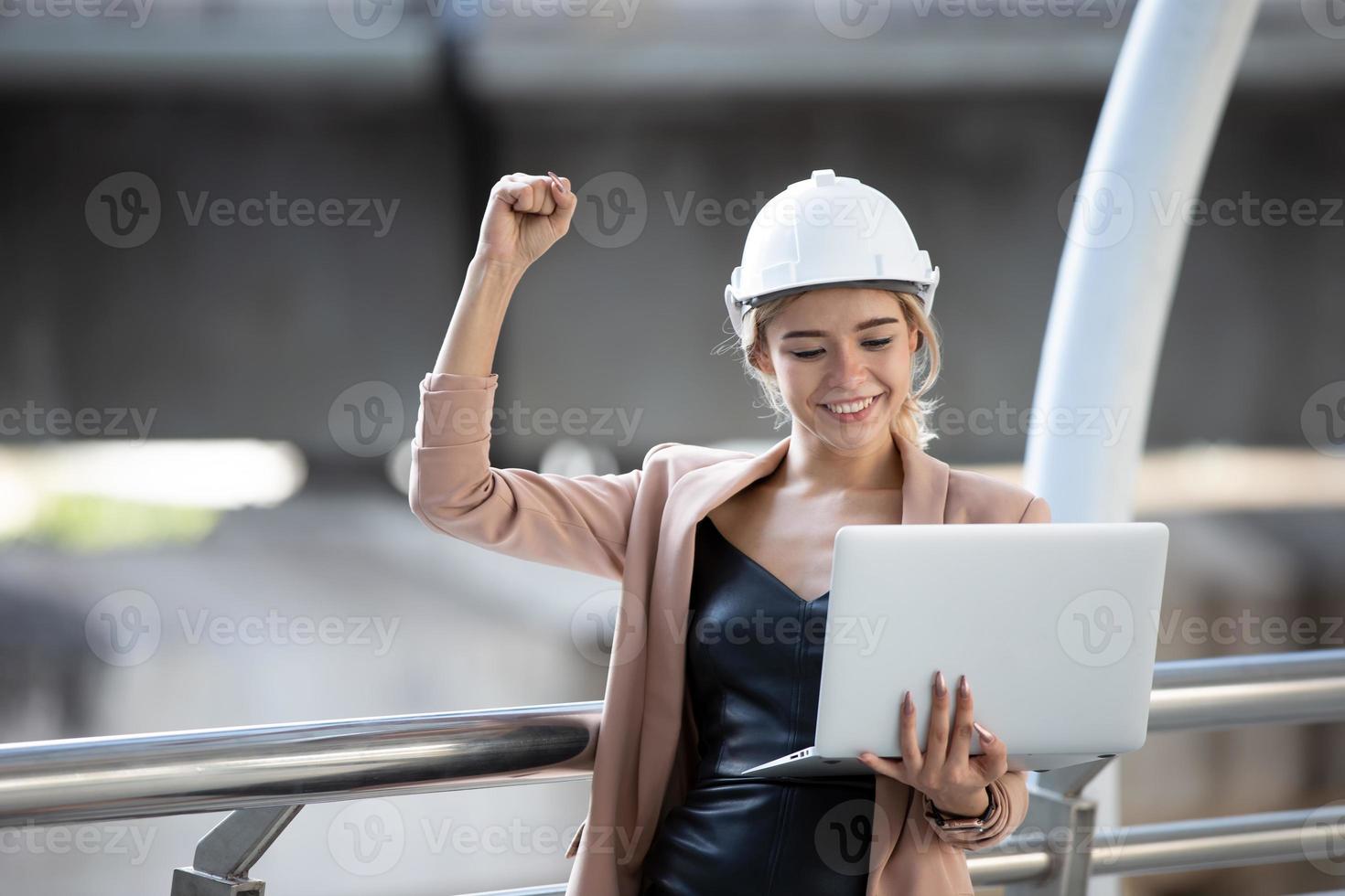 Female construction site engineer with laptop. photo