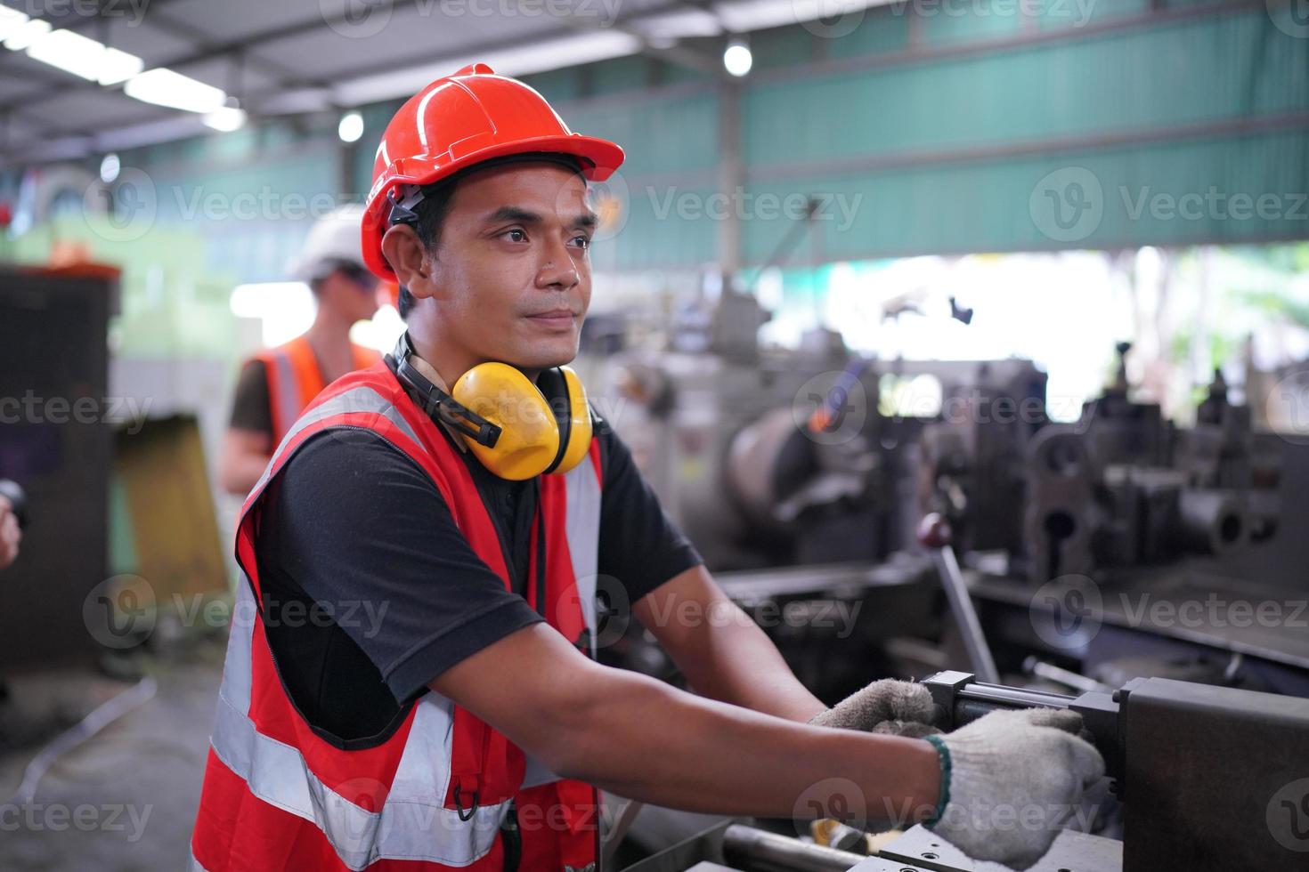 Maintenance Engineers is working in front of the automated CNC machinery repair on a maintenance checklist at the production line. photo