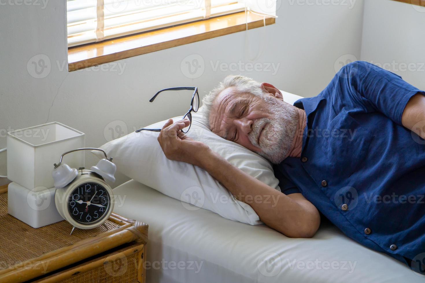 Senior male gray hair sleep on bed. photo