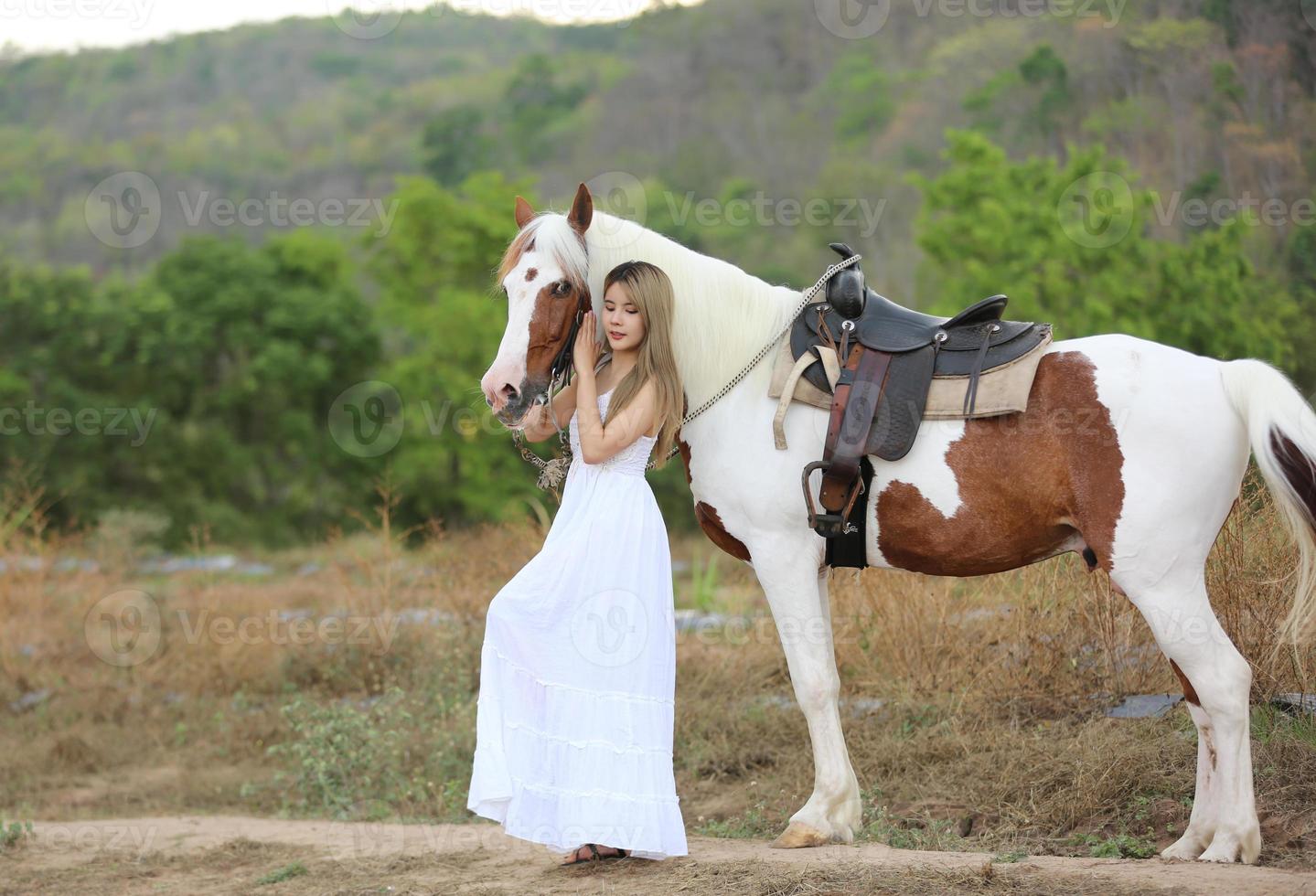 Young woman with her horse in evening sunset light. Outdoor photography with fashion model girl. Lifestyle mood photo