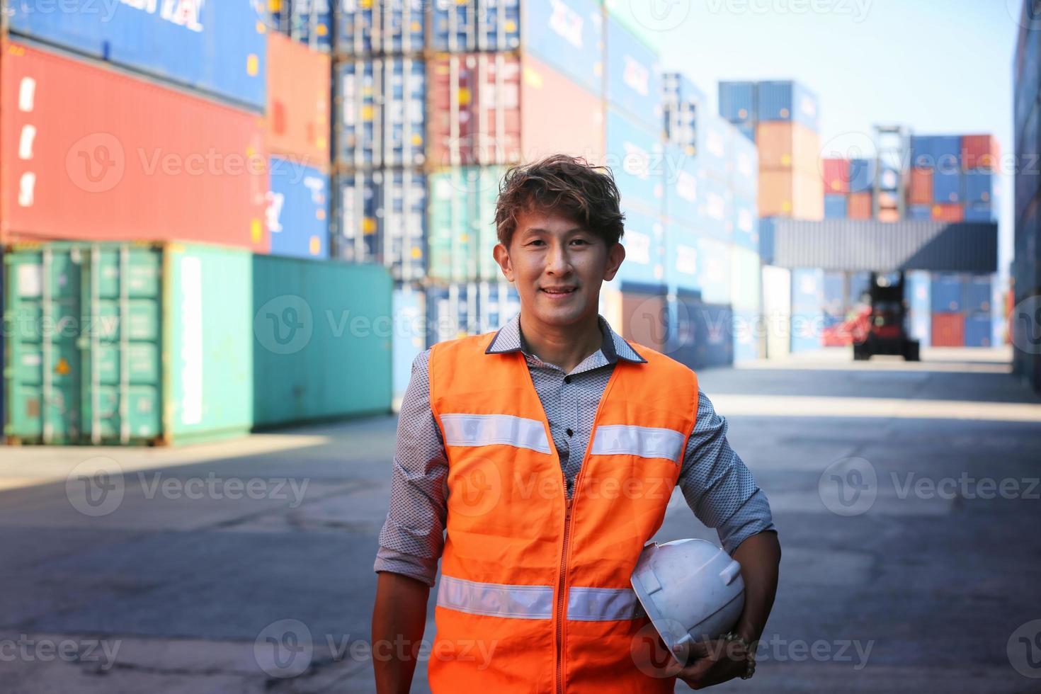 Asian Foreman checking containers for ship at terminal port. photo