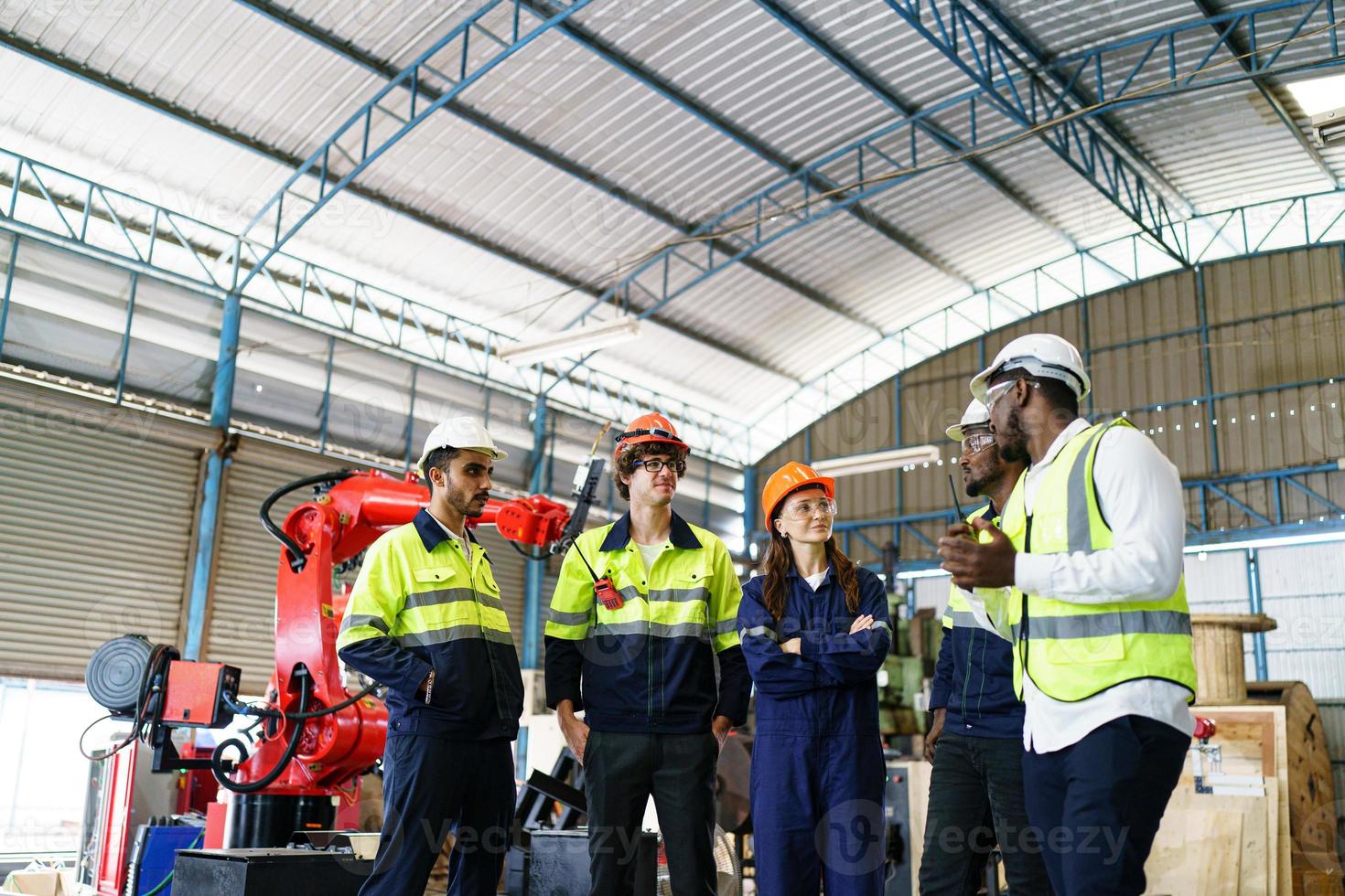 Industrial engineer or worker wearing a helmet while standing in a heavy industrial factory. The Maintenance looking of working at industrial machinery and check security system setup in factory. photo