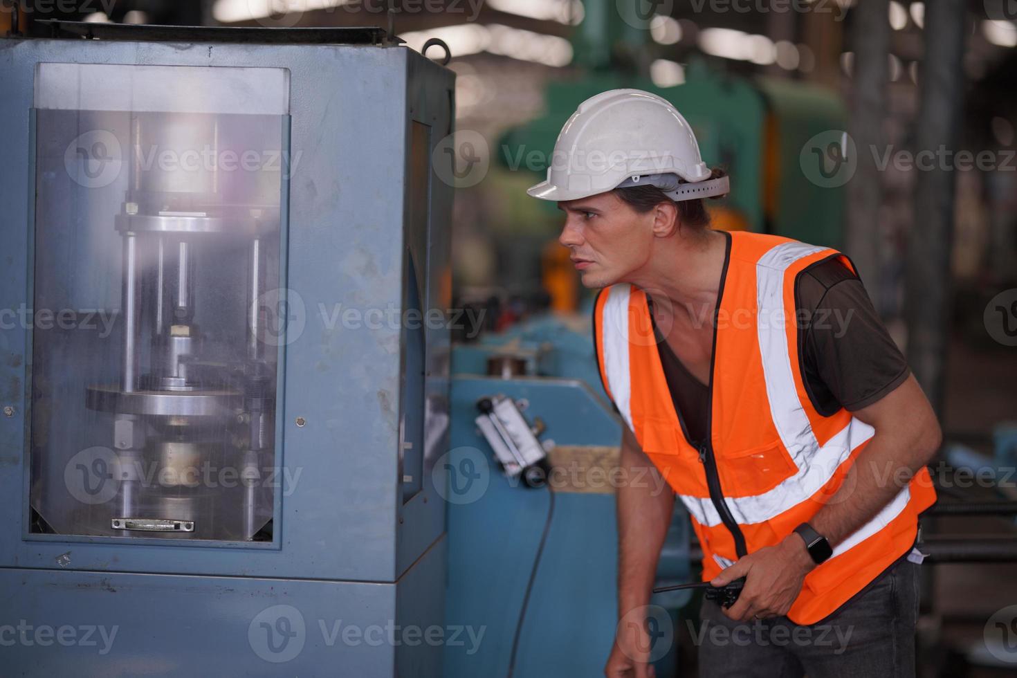 Maintenance Engineers is working in front of the automated CNC machinery repair on a maintenance checklist at the production line. photo
