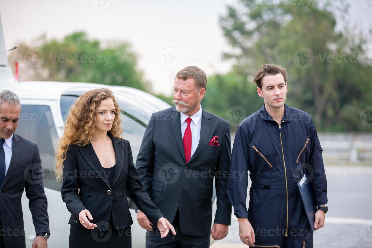 Successful business people standing together widen out showing strong relationship of worker community. A team of businessman and businesswoman expressing a strong group teamwork at the modern office. photo