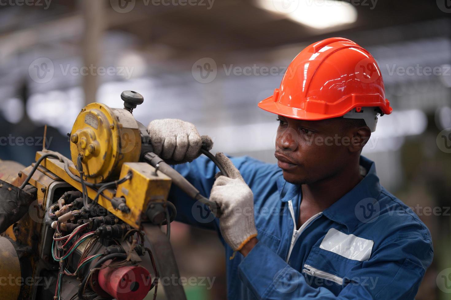 Maintenance Engineers is working in front of the automated CNC machinery repair on a maintenance checklist at the production line. photo