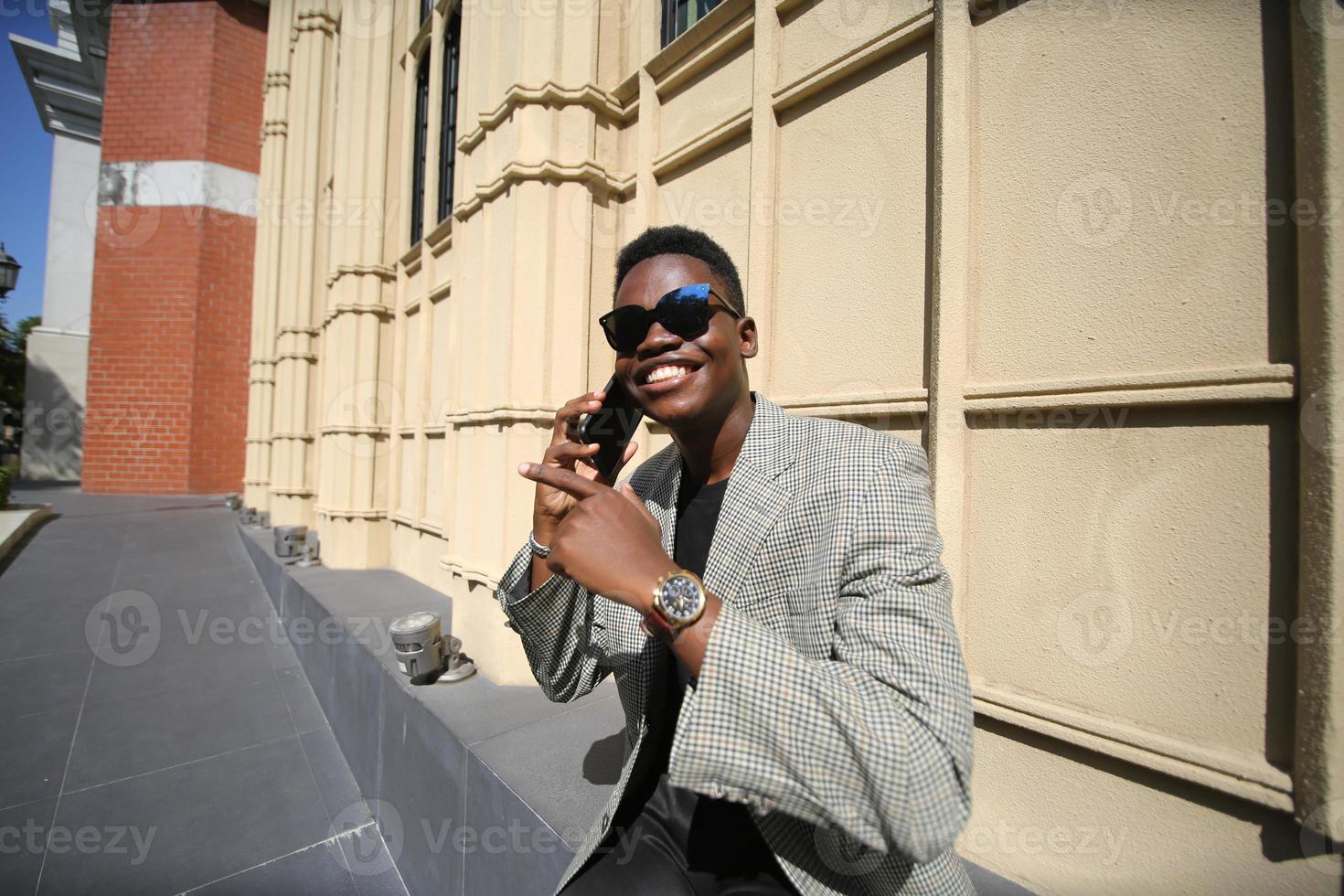 Afro American man having fun walking in city center - Happy young guy enjoying time a sunset outdoor - Millennial generation lifestyle and positive people attitude concept photo