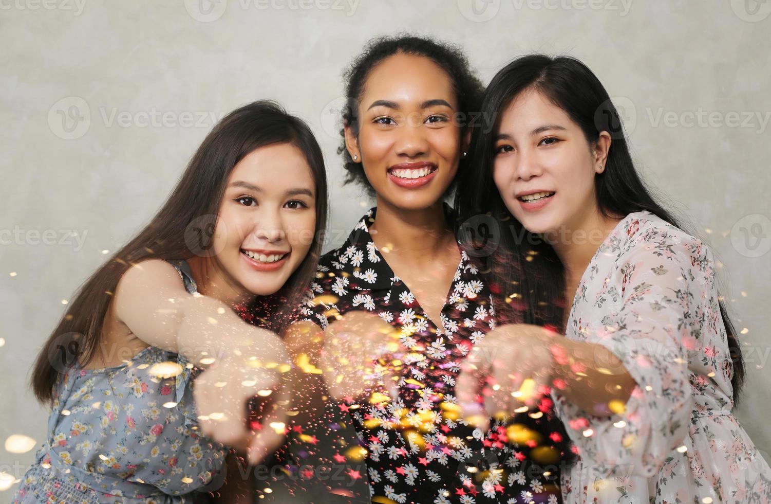 Close up indoor lifestyle portrait of three funny young friends have fun and pretending faces. Home party mood. International Women's Day. Group of three happy young women having smiling. generation Z photo