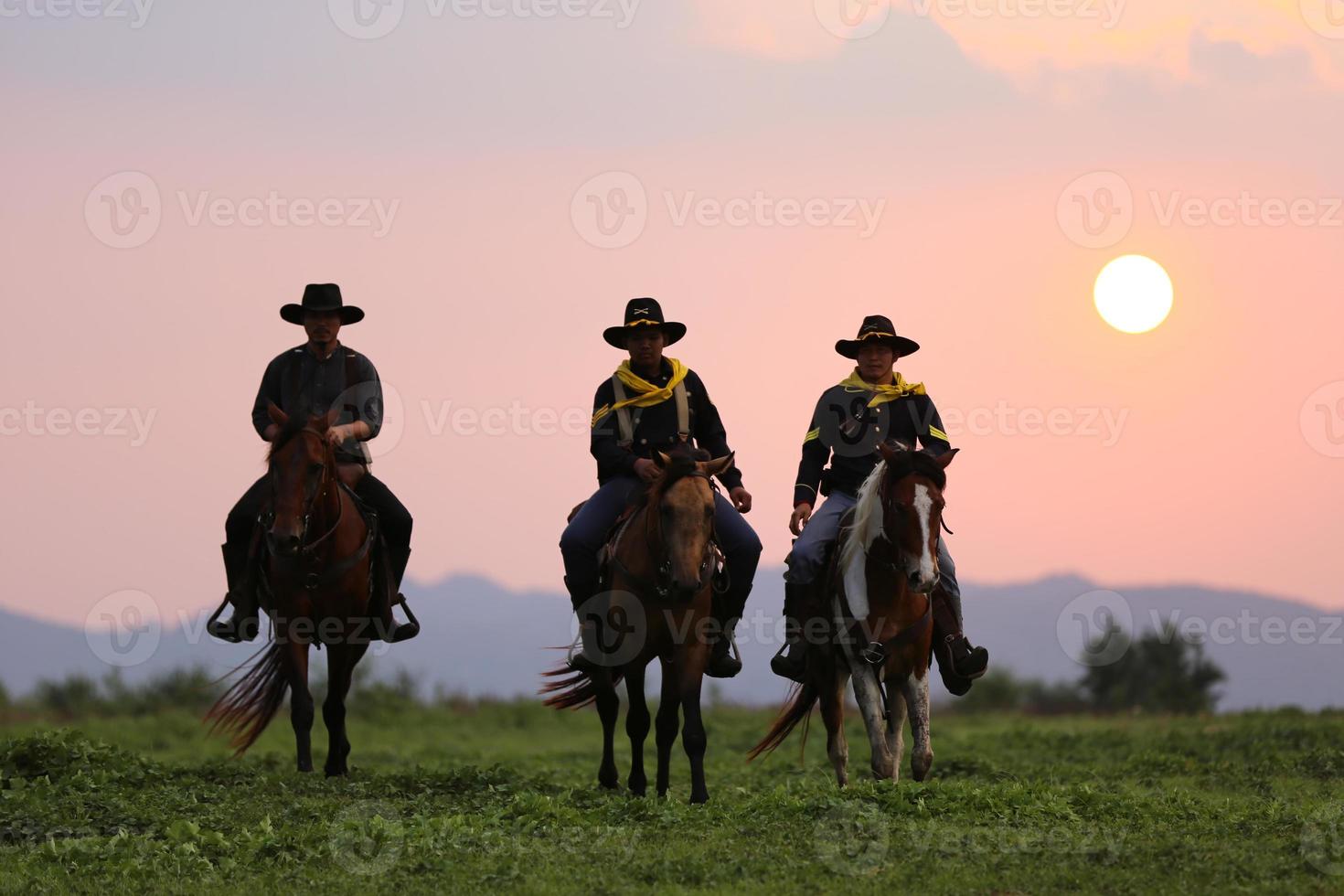 ilhouette vaquero a caballo contra una hermosa puesta de sol, vaquero y caballo a primera luz, montaña, río y estilo de vida con fondo de luz natural foto