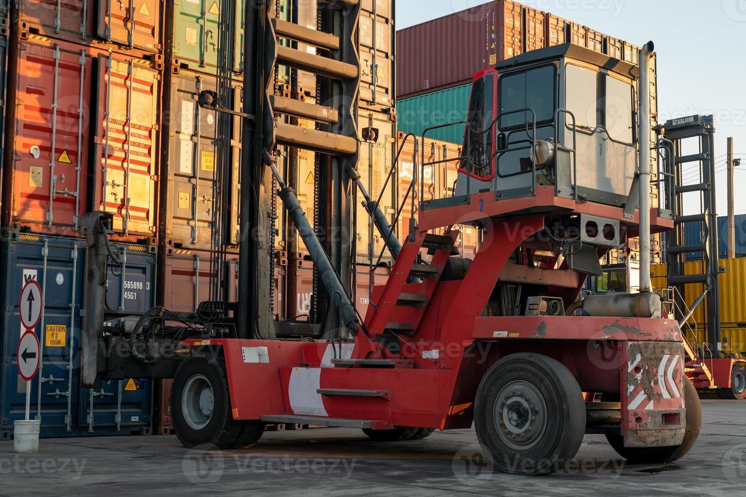 Foreman control loading Containers box from Cargo freight ship for import export. photo