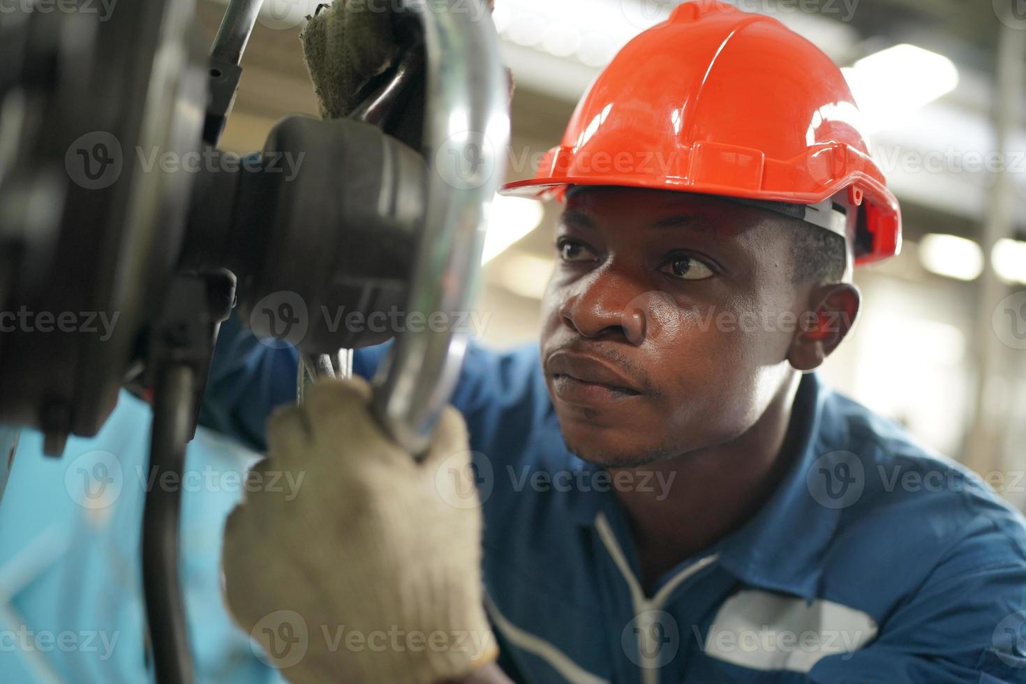 Maintenance Engineers is working in front of the automated CNC machinery repair on a maintenance checklist at the production line. photo