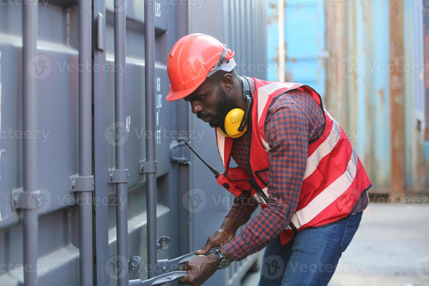 Foreman control loading Containers box from Cargo freight ship for import export. photo