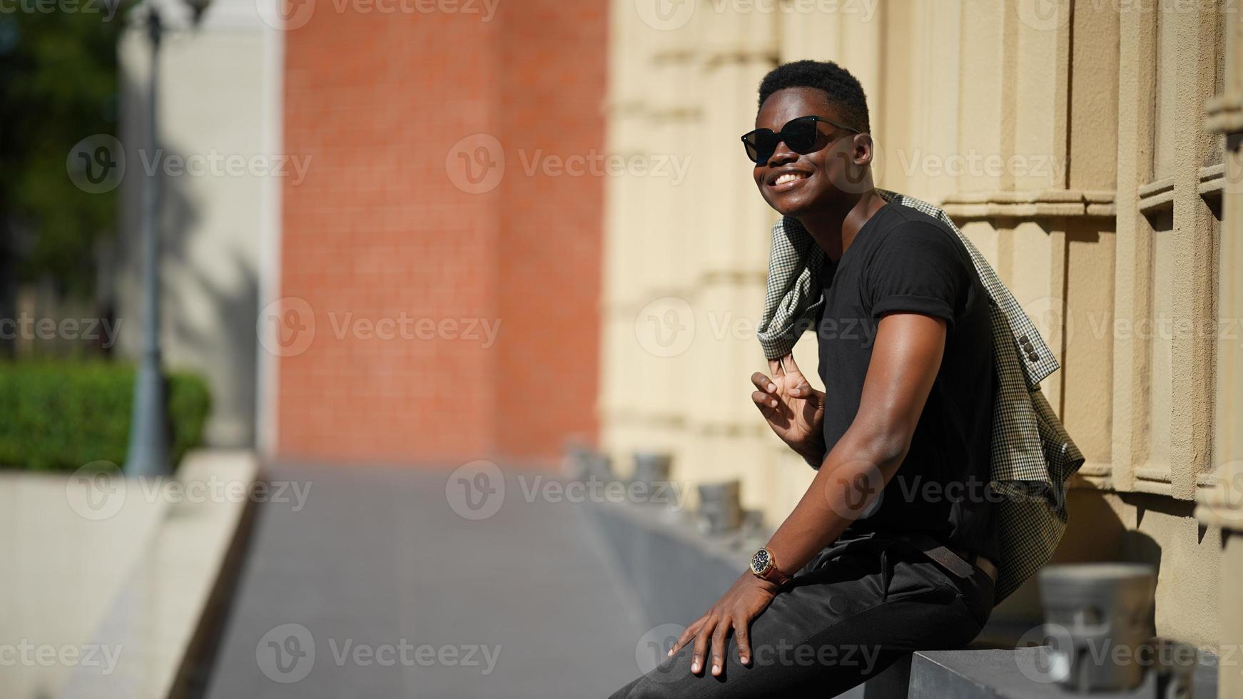 Afro American man having fun walking in city center - Happy young guy enjoying time a sunset outdoor - Millennial generation lifestyle and positive people attitude concept photo